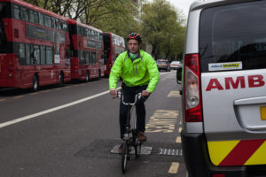 cyclist and buses on street in London